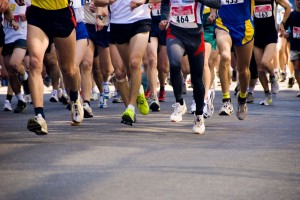 Detail of the legs of runners at the start of a marathon race