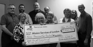 Women's Auxiliary members holding a check for $9,400.00